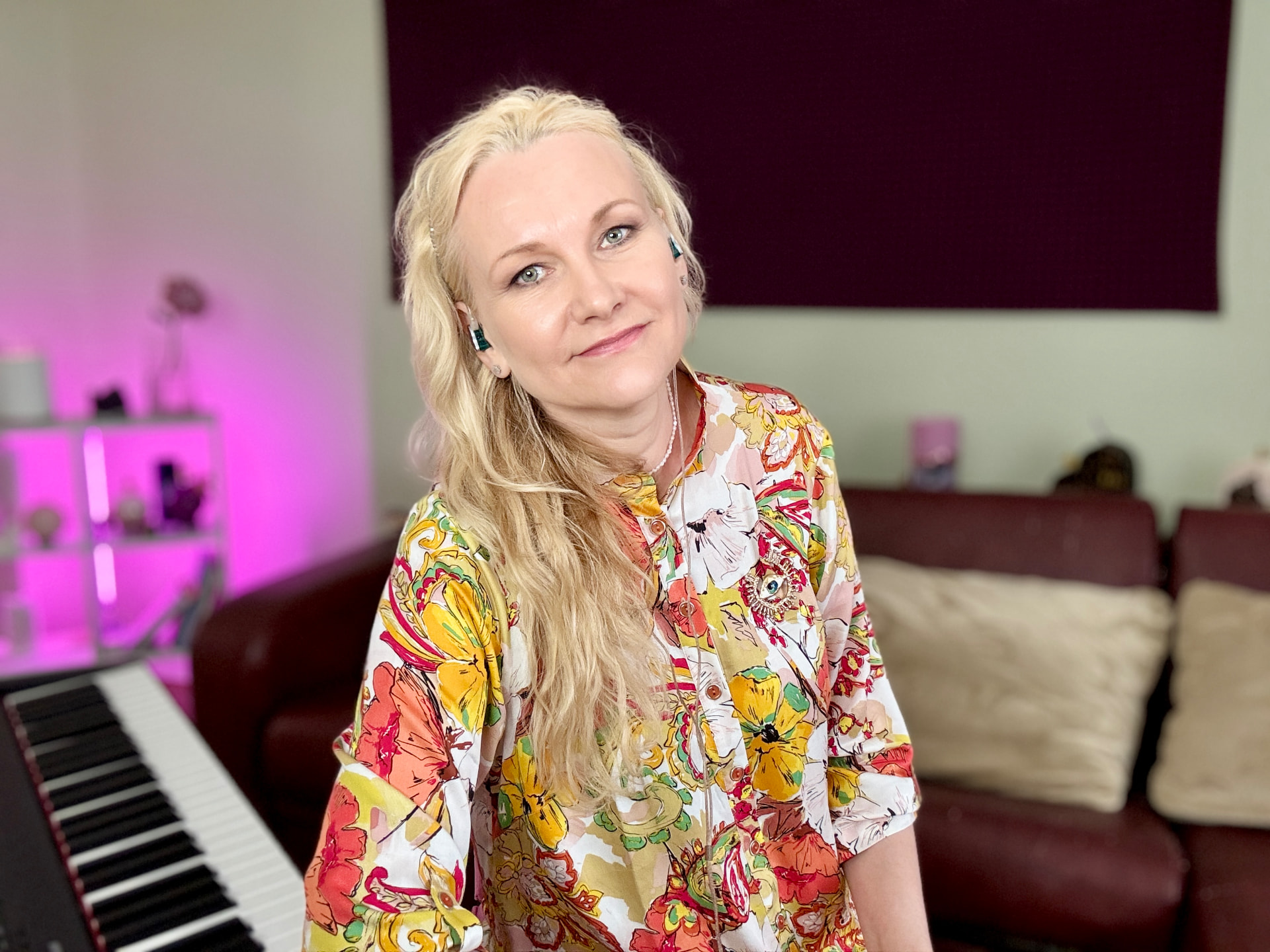 Juliana Polansky at the piano wearing in-ear monitors during a mindful singing practice session